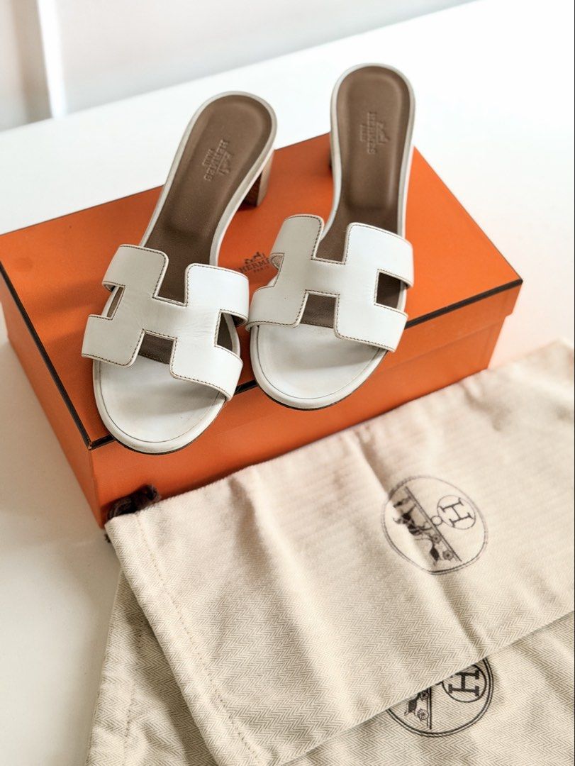 Hermes White Oasis Heel Sandals (Category: Heels) located in Tarlac. Submitted by official_kiyowo.vintage (Listing ID 1470472171, Image 1). Description: - Authentic white Hermes heeled sandals - Iconic cutout H strap design - 25cm size - Comfortable tan leather insole and stacked block heel - Easy slip-on style - Includes original orange box and 2 dust bags SF not included.