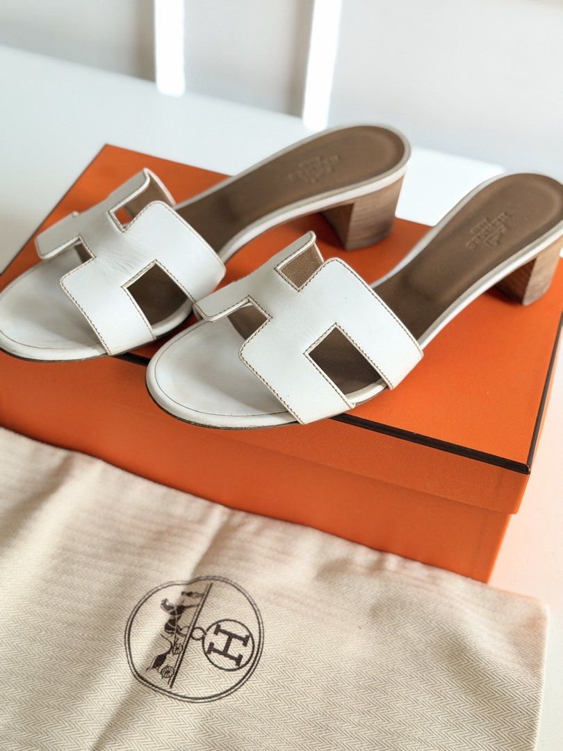 Hermes White Oasis Heel Sandals (Category: Heels) located in Tarlac. Submitted by official_kiyowo.vintage (Listing ID 1470472171, Image 3). Description: - Authentic white Hermes heeled sandals - Iconic cutout H strap design - 25cm size - Comfortable tan leather insole and stacked block heel - Easy slip-on style - Includes original orange box and 2 dust bags SF not included.
