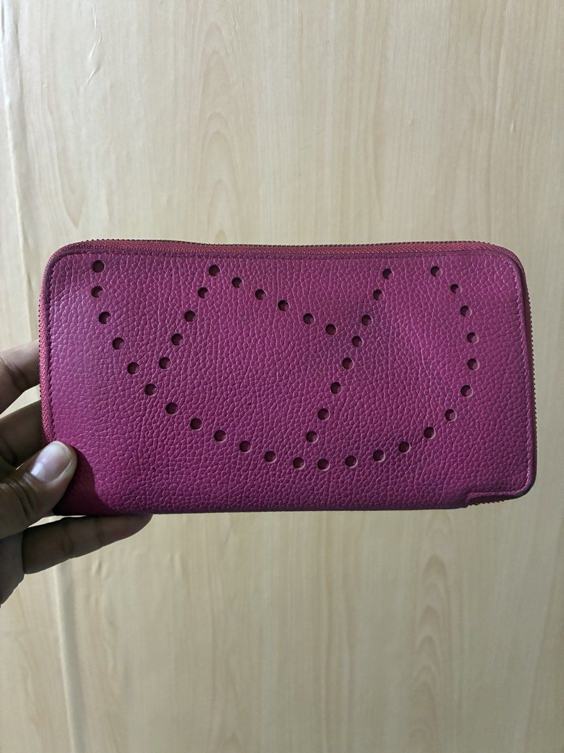 Hermès Silk'In Azap Long Wallet Pink (Category: Wallets & Card holders) located in Placer. Submitted by talaalond61563 (Listing ID 1470419655, Image 1). Description: - Brand: Hermès - Material: Grainy leather in bright pink with matching interior lining - Design: Iconic perforated 'H' logo on the front - Hardware: Silver-tone with engraved logo pull - Compartments: Multiple card slots and secure inner zippered pocket - Condition: Good pre-loved c
