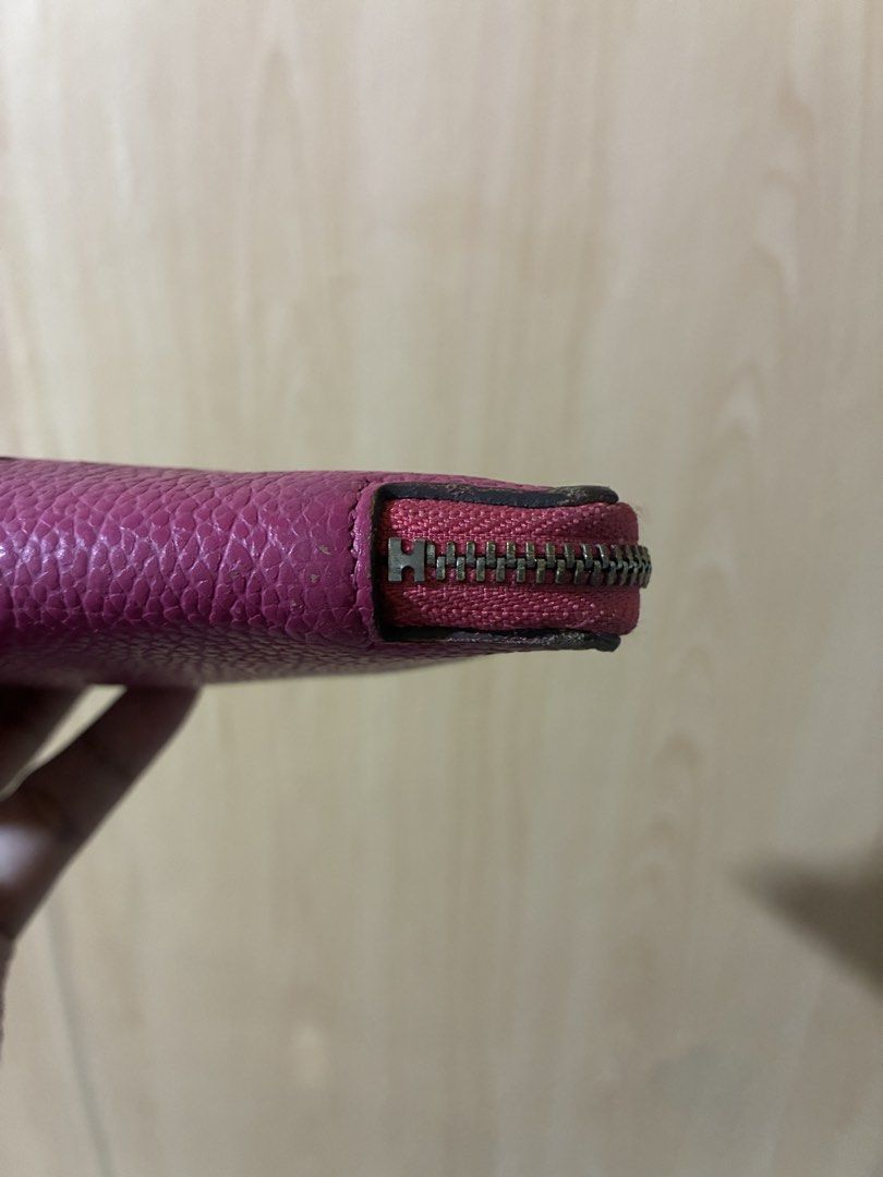 Hermès Silk'In Azap Long Wallet Pink (Category: Wallets & Card holders) located in Placer. Submitted by talaalond61563 (Listing ID 1470419655, Image 2). Description: - Brand: Hermès - Material: Grainy leather in bright pink with matching interior lining - Design: Iconic perforated 'H' logo on the front - Hardware: Silver-tone with engraved logo pull - Compartments: Multiple card slots and secure inner zippered pocket - Condition: Good pre-loved c
