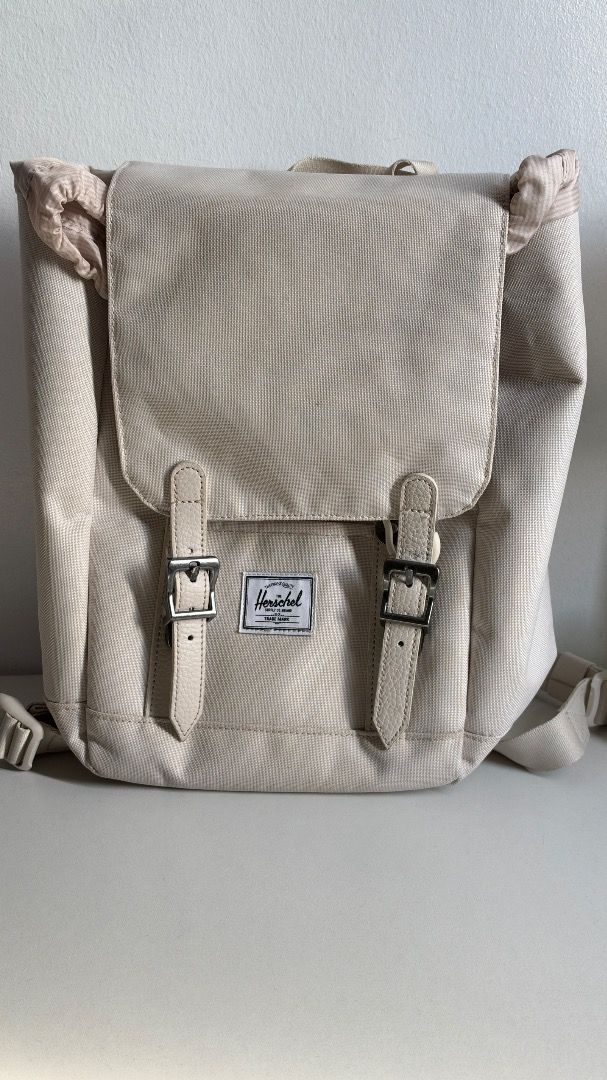￼Herschel Retreat Mini Backpack Moonbeam Us 10L (Category: Backpacks) located in Caloocan City. Submitted by tkeiann-15790 (Listing ID 1470396850, Image 2). Description: - Authentic Herschel backpack - Color: Cream with light tan faux leather accents - Flap top design with dual magnetic buckle straps and drawstring closure - Front storage pocket with classic Herschel woven label - Comfortable adjustable shoulder straps - Ideal everyday bag for sc