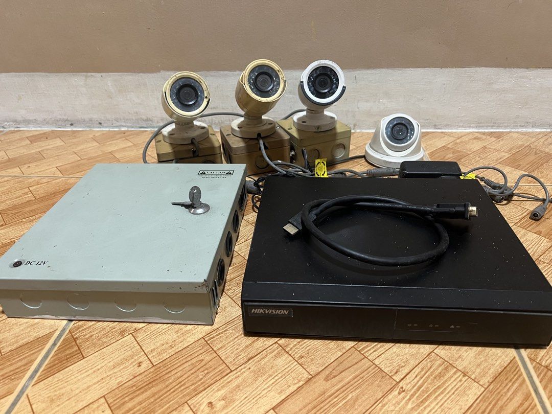 Hikvision DVR with Security Cameras and Power Supply Box (Category: Security Systems & CCTV Cameras) located in Malabon City. Submitted by demenice (Listing ID 1470392025, Image 1). Description: - Complete Hikvision DVR security system - Includes 4 bullet-style cameras and 1 dome camera - Comes with a metal power supply box (with key) and necessary cables - Tested and fully working - Shows minor cosmetic wear and dust from previous use - Ideal an