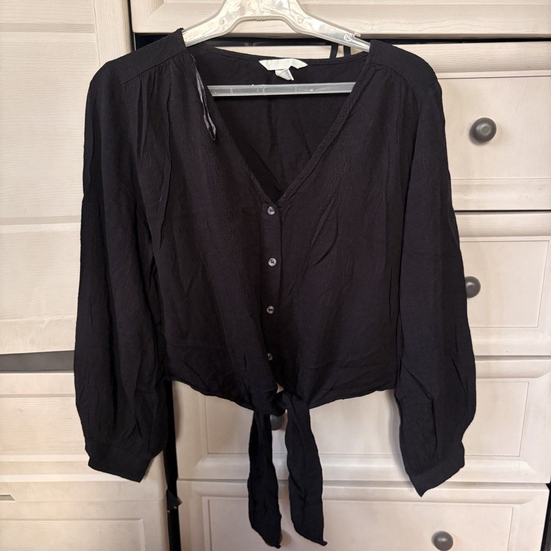 H&M Black Long Sleeve Tie Front Blouse (Category: Longsleeves) located in Makati City. Submitted by iu__00 (Listing ID 1470445075, Image 1). Description: - Brand: H&M - Color: Black - Size: Med - Style: Long sleeve crop top with V-neckline and button-front closure - Details: Trendy self-tie hem and lightweight textured fabric - Condition: Great pre-loved/new basic piece for layering or standalone wear.