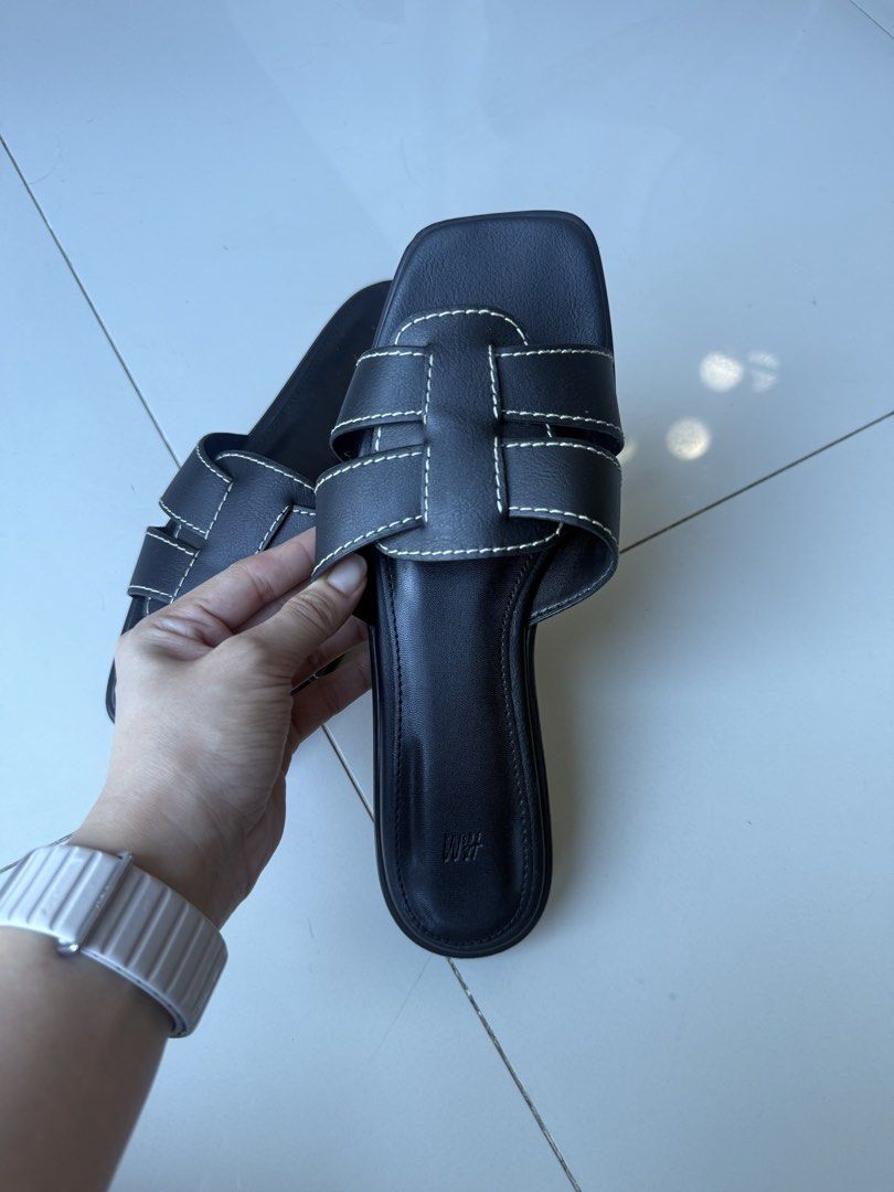 H&M Black Slide Sandals (Category: Flats & Sandals) located in Makati City. Submitted by bcazu (Listing ID 1470356404, Image 2). Description: H&M Sandals with contrast stitching (Hermes inspired) Size: 39 RFS: Used lightly - size too big for me - Color: Black with white contrast stitching - Design: Square toes, crossover upper straps, slip-on style - Perfect for casual daily outfits Meet up at Eastwood or delivery c/o buyer.
