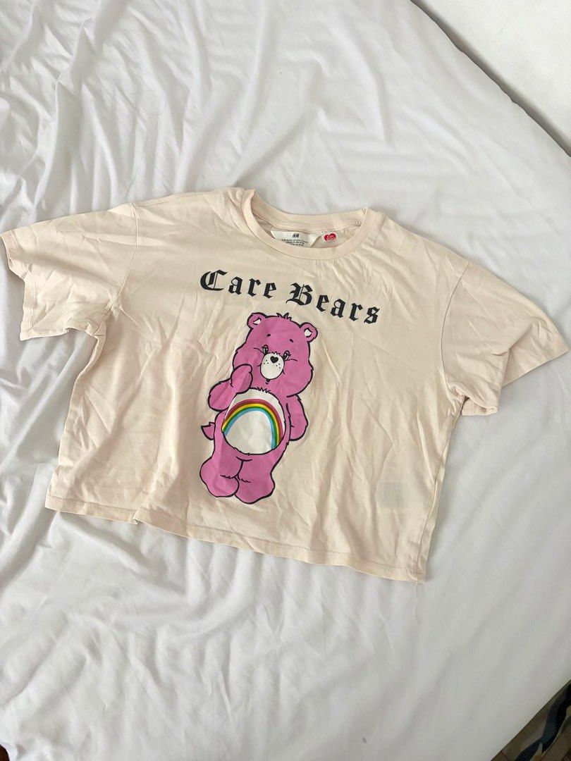 H&M Care Bears Graphic Tee Size 12-14 (Category: Shirts) located in Las Pinas. Submitted by thriftedfinds_ (Listing ID 1470354976, Image 1). Description: - Brand: H&M x Care Bears Official Collaboration - Color: Cream with large pink graphic and edgy gothic text - Size: EUR 146/152 or US 12/14 - Material: Super soft 100% cotton - Style: Short sleeve crew neck tee - Condition: Excellent, ready to ship!.