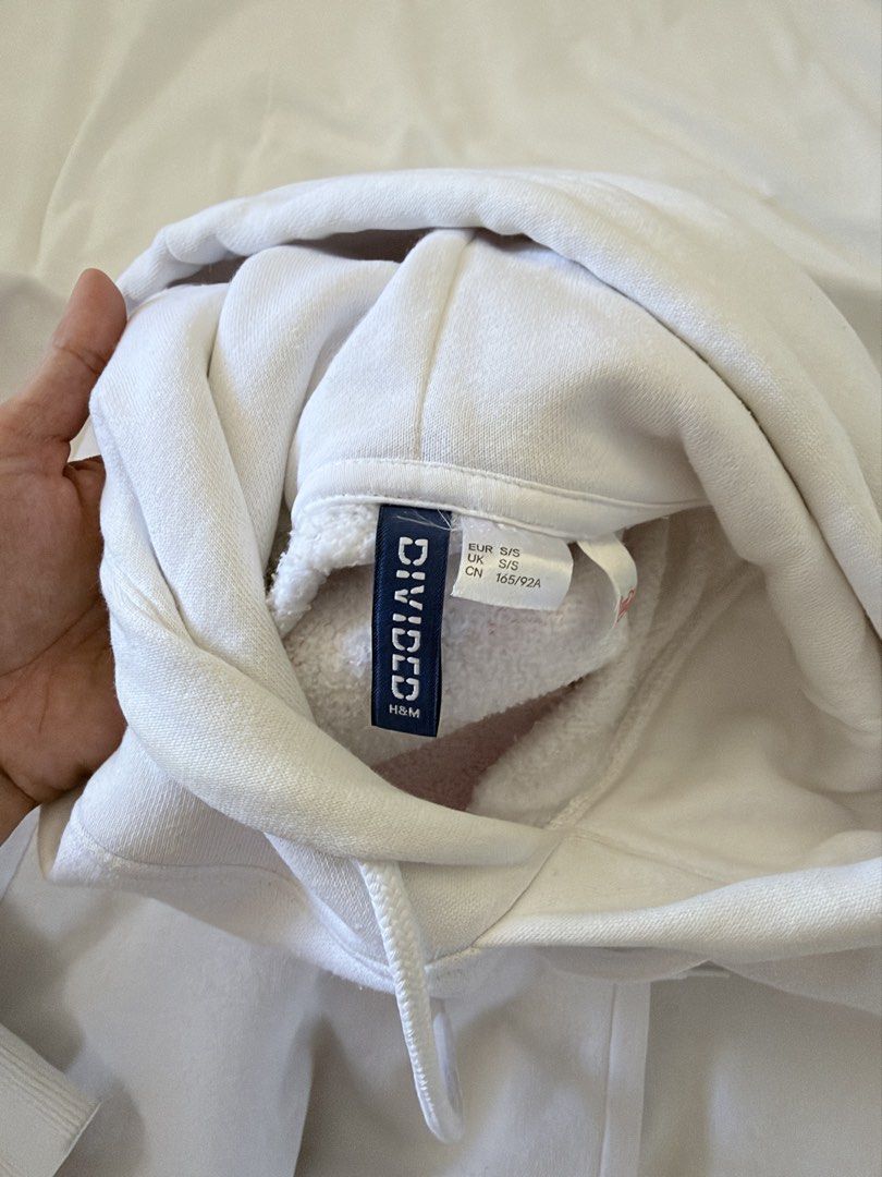 H&M Divided Coca Cola White Hoodie Size S (Category: Hoodies) located in Binan City. Submitted by wornbygwen (Listing ID 1470489749, Image 3). Description: - Brand: H&M Divided - Design: Coca Cola chest graphic - Color: Clean white - Size: S (EUR/UK S, CN 165/92A) - Features: Drawstring hood, front kangaroo pocket - Fit: Classic relaxed fit, super comfortable for daily wear - Condition: Well-maintained.