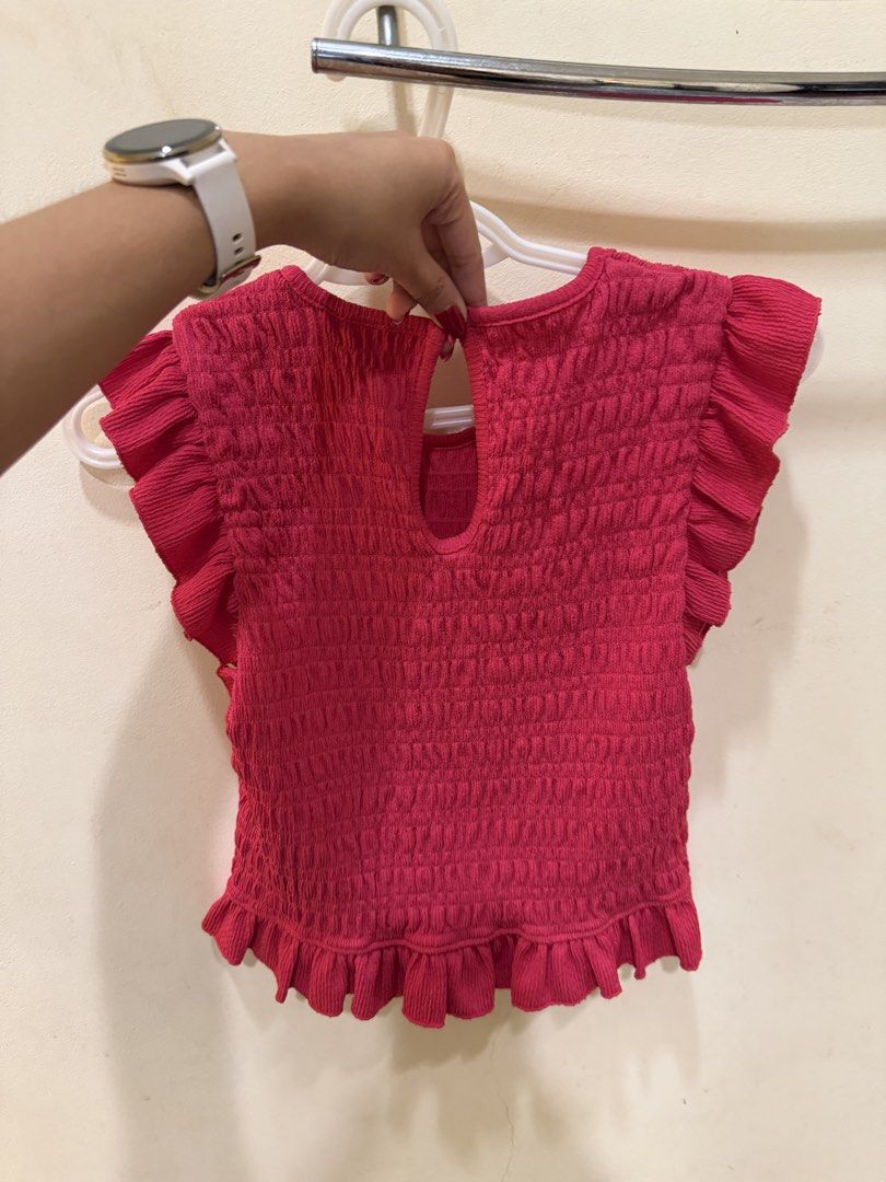 H&M Pink Smocked Ruffle Top (Category: Blouses) located in Las Pinas. Submitted by privari (Listing ID 1470389101, Image 3). Description: - Brand: H&M - Size: M - Color: Bright red - Material: Fully textured, stretchy fabric - Design: Ruffle cap sleeves, ruffled hem, and back keyhole button closure - Styling: Easily pairs with high-waisted jeans or skirts.