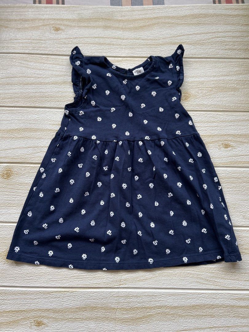 H&M soft cotton dress (Category: Babies & Kids Fashion) located in Cebu City. Submitted by yjainani (Listing ID 1470440053, Image 1). Description: navy blue soft cotton jersey dress with a small white floral or daisy print and ruffled flutter sleeves .