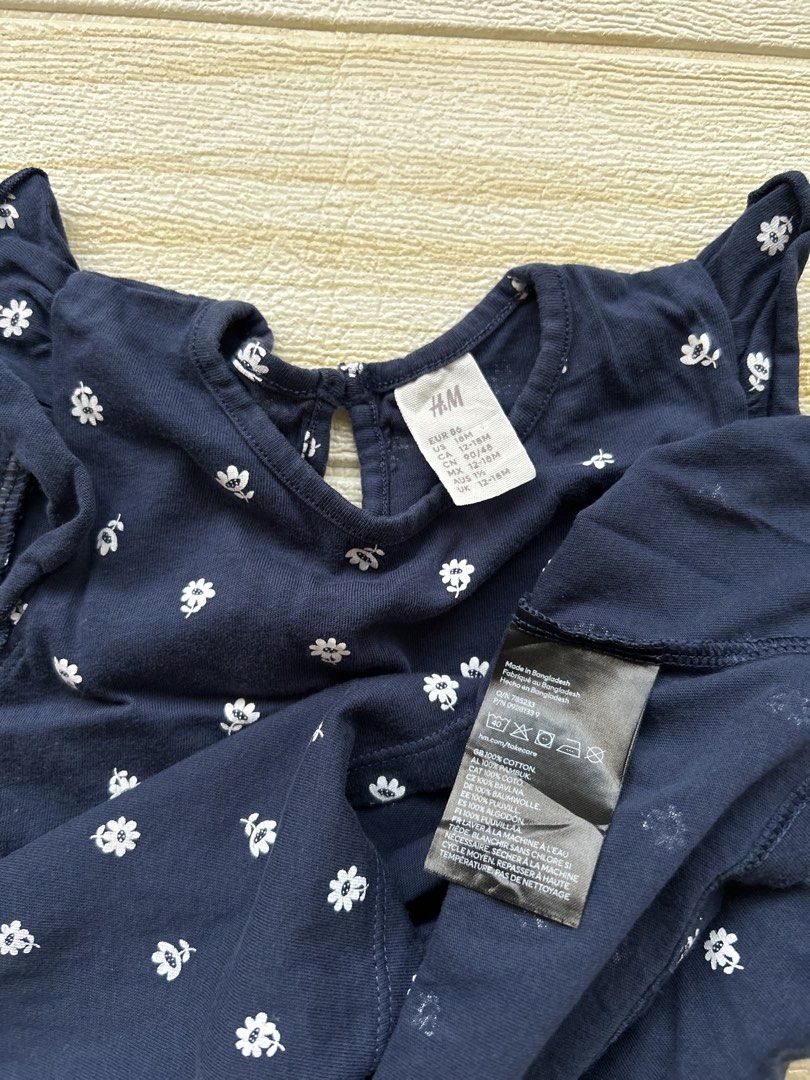 H&M soft cotton dress (Category: Babies & Kids Fashion) located in Cebu City. Submitted by yjainani (Listing ID 1470440053, Image 3). Description: navy blue soft cotton jersey dress with a small white floral or daisy print and ruffled flutter sleeves .