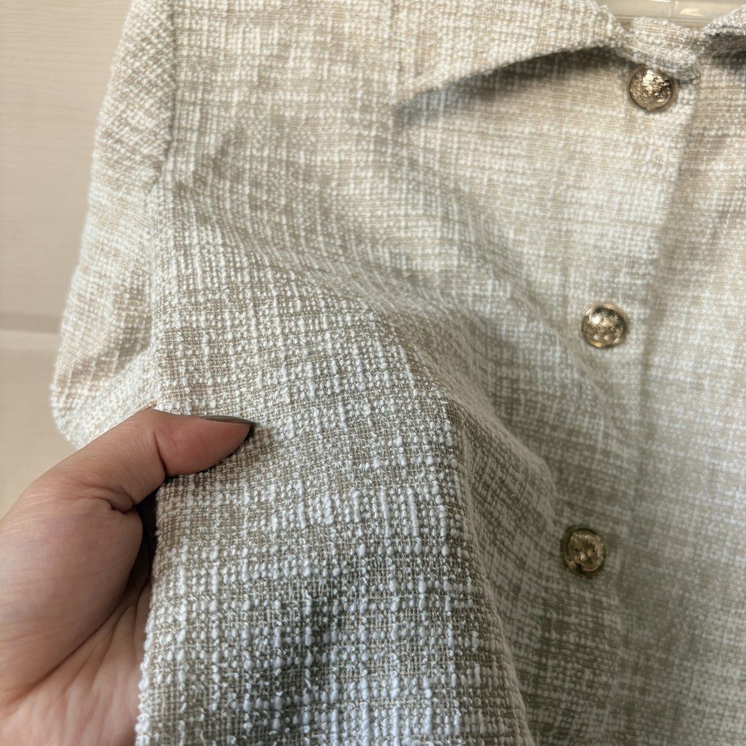 H&M Tweed Crop Top (Category: Blouses) located in Makati City. Submitted by iu__00 (Listing ID 1470444194, Image 2). Description: - Brand/Model: H&M - Size: Small - Color/Fabric: Beige and white tweed - Design: Short sleeves, collar, button-down front with metallic ornate buttons - Fit: Cropped length, structured fit - Condition: Clean and well cared for - Style Tip: Great layering piece for work or going out.