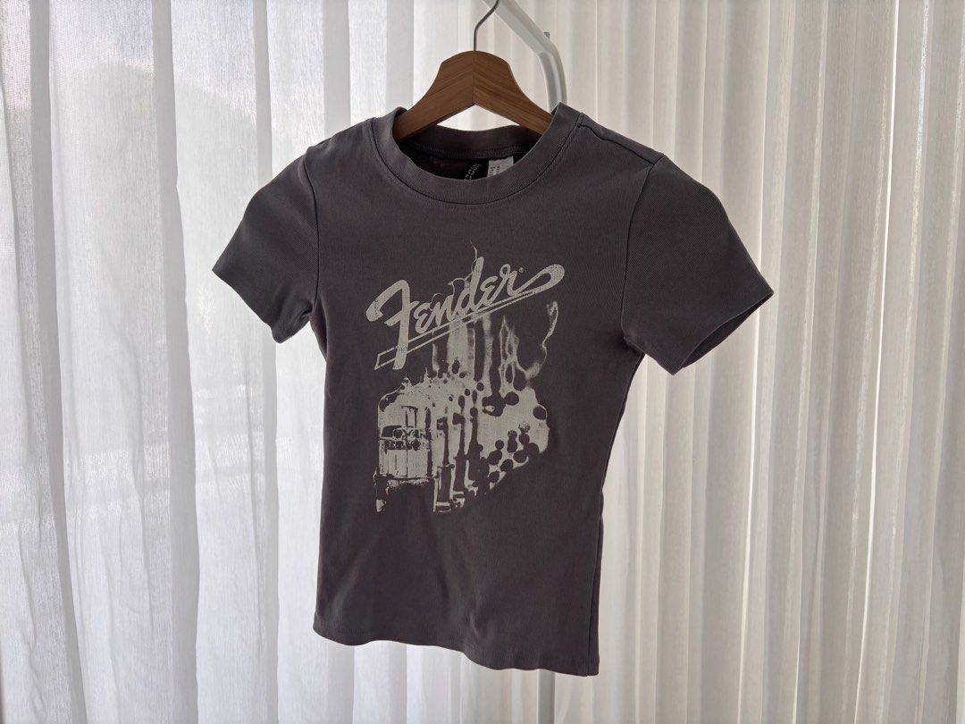 H&M x Fender graphic shirt (Category: Shirts) located in Manila. Submitted by gothclaudia (Listing ID 1470422320, Image 1). Description: RFS: decluttering my closet! :) - bought in 2023, hardly used since - H&M Divided - size XS - Fitted crewneck, short sleeves, cinched waist, stretchy cotton blend - good for casual band fashion!.