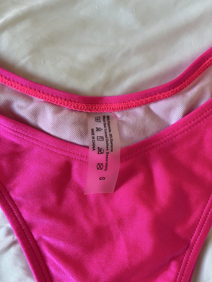 Hot Pink Swimsuit (Category: Bikinis & Swimsuits) located in Taytay. Submitted by prelovedbyblaire (Listing ID 1470384644, Image 2). Description: - Hot pink bikini set - Size: S (tag attached) - Style: Bandeau top with center ring detail and high-cut bottoms - Material: 80% polyamide, 20% elastane - Care: Wash dark colors separately - Condition: Brand new.