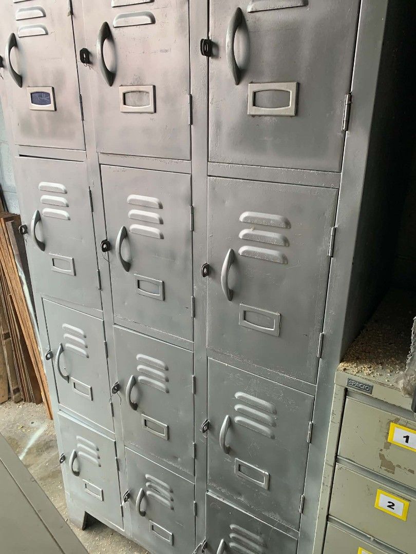 Industrial Grey Metal Multi-Tier Storage Locker Cabinet (Category: Shelves, Cabinets & Racks) located in Manila. Submitted by cleverocean.10acf9 (Listing ID 1470474345, Image 1). Description: - Type: Industrial-style grey metal locker unit - Build: Solid metal construction, heavy and durable - Features: Multiple compartments, ventilation slots, and name card holders on each door - Storage: Spacious interior for ample storage - Ideal Use: Perfect 
