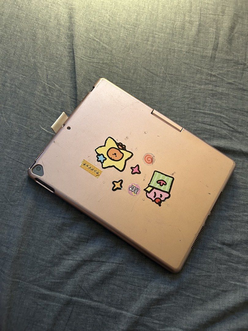 ipad 9th gen 64GB (sample pics in 3rd & 4th slide) (Category: Cases & Sleeves) located in Binan City. Submitted by valentinexx (Listing ID 1470432169, Image 2). Description: - Color: Rose gold - Features a built-in QWERTY keyboard and trackpad - Decorated with cute stickers near the trackpad and corners - Transforms your iPad into a convenient mini laptop setup - Fully functional keys and solid hinge - Condition: Light wear from normal daily use,