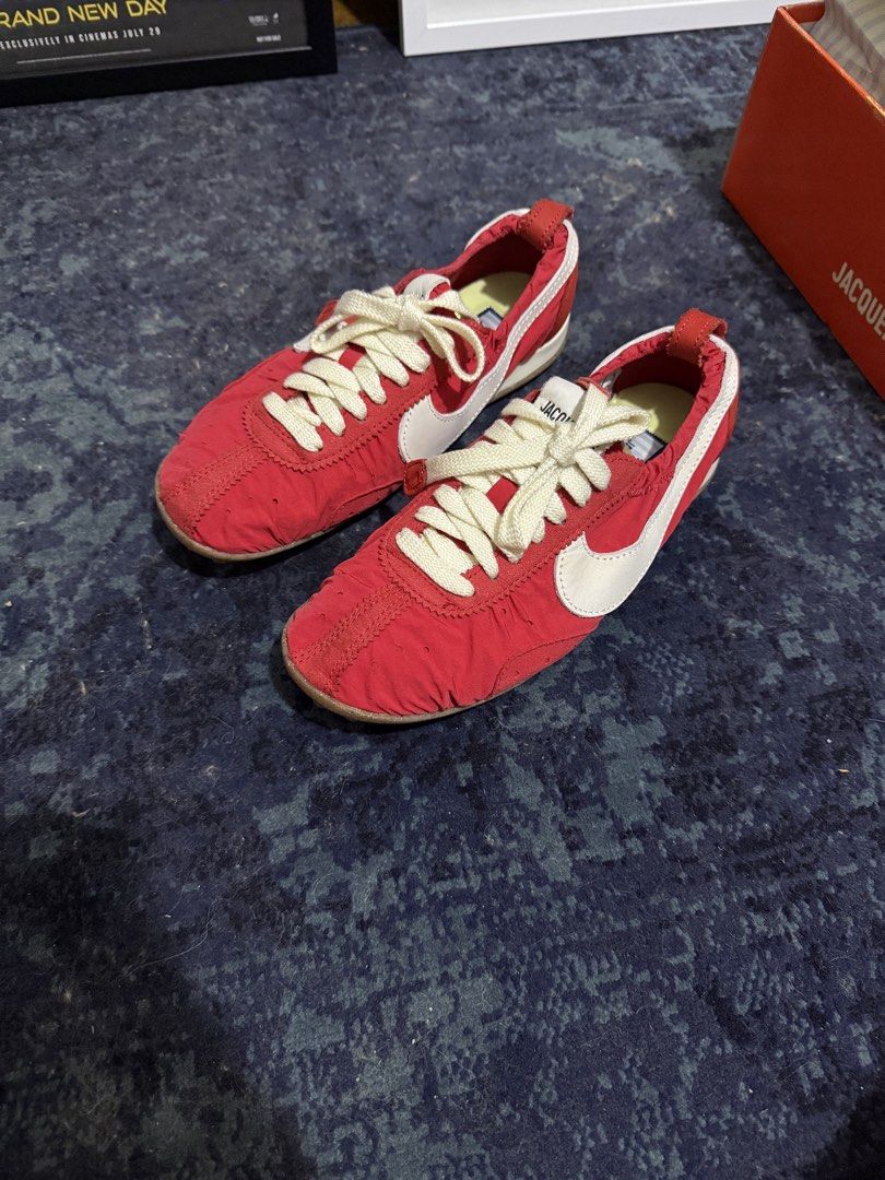 Jacquemus x Nike Moon Shoe SP (Category: Sneakers) located in Quezon City. Submitted by oksanaber (Listing ID 1470555975, Image 1). Description: Jacquemus and Nike collaboration sneakers in striking red. Chunky white swoosh on the side with textured nylon upper construction. Unique speckled gum waffle outsole underneath. Debossed Jacquemus branding clearly stamped on the rear heel tab and custom striped insoles inside. Thick cream laces with meta