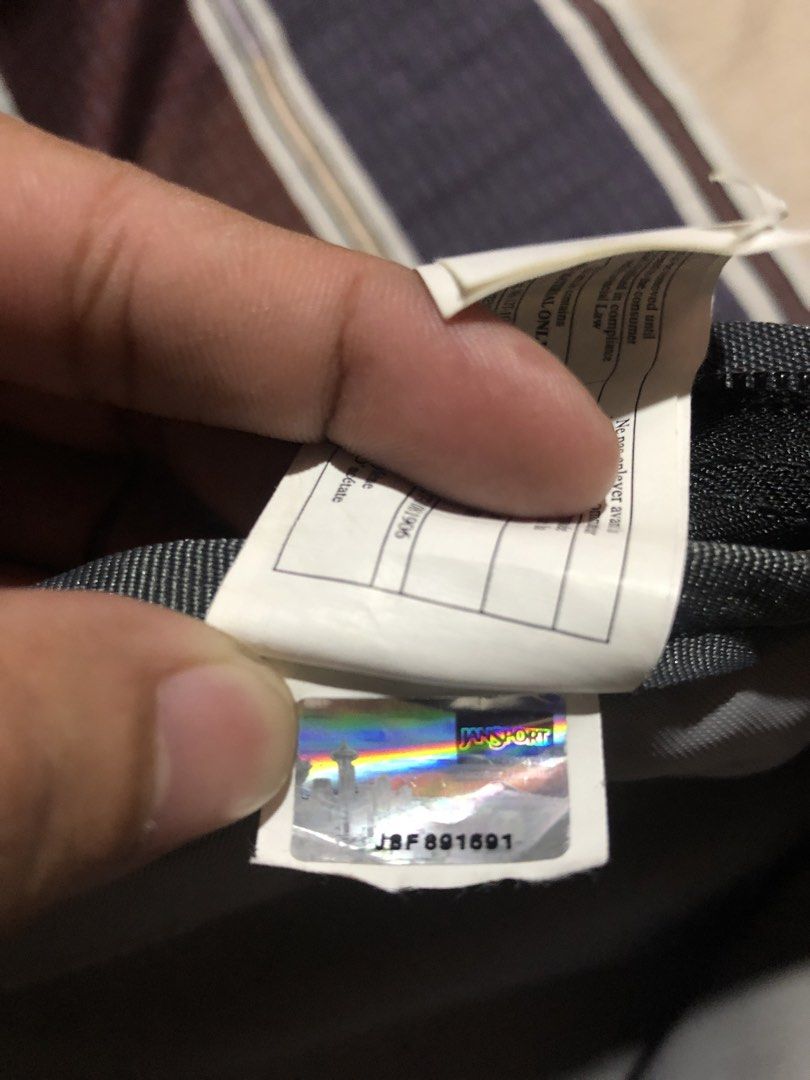 JanSport TDN7 Grey Backpack (Category: Backpacks) located in Manila. Submitted by bakithrift213 (Listing ID 1470455116, Image 3). Description: - Authentic JanSport backpack in classic grey - Made from durable 100% polyester - Multiple zippered compartments for easy organization - Convenient side mesh pocket for water bottles - Padded shoulder straps for all-day comfort - Includes hologram authenticity tag inside - Ideal for school, work, or daily