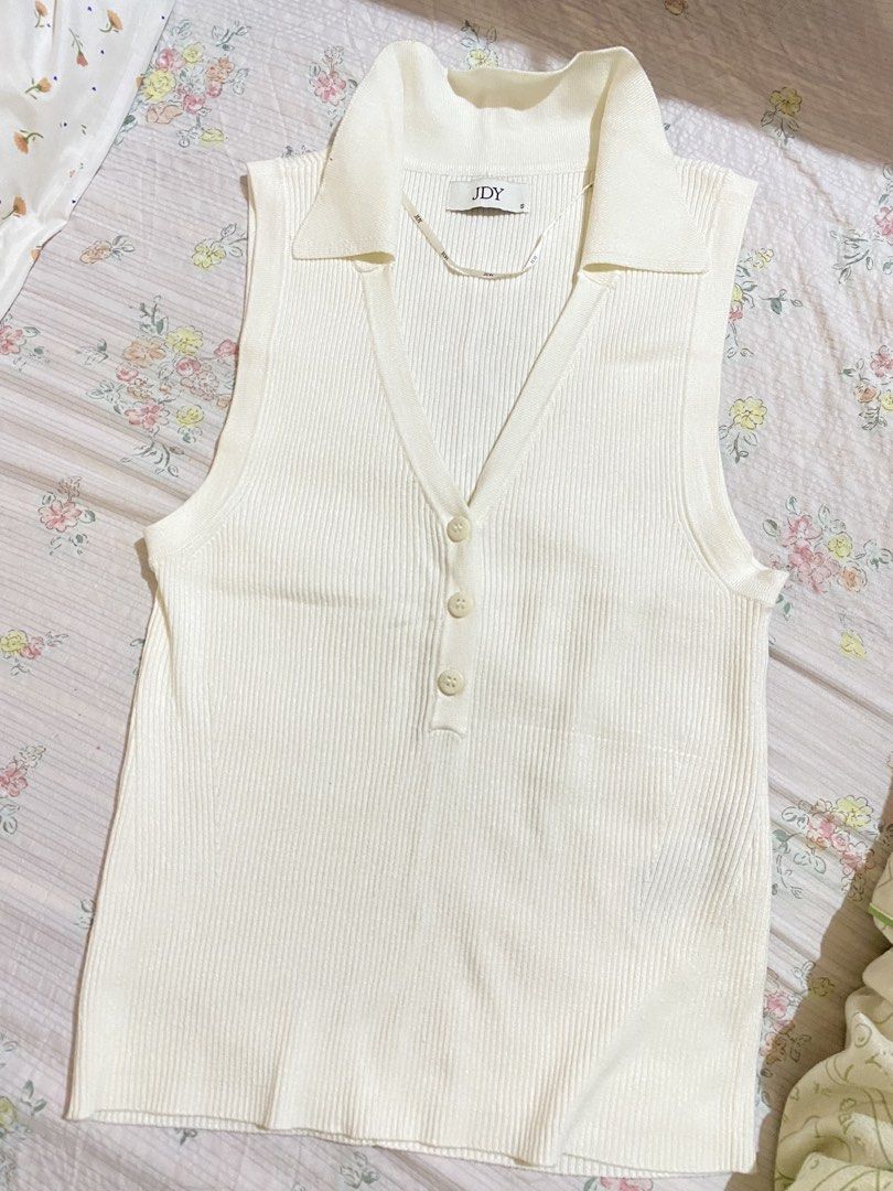 (JDY) White Ribbed Collared Sleeveless Knit Top Size S (Category: Sleeveless) located in Imus. Submitted by softclosetph (Listing ID 1470488516, Image 1). Description: - Brand: JDY - Color: White - Size: S (fits true to size) - Material: Lightweight, stretchy ribbed knit - Details: Collared V-neckline with 3 front buttons - Condition: Brand new with tag attached - Style: Casual basic top, perfect for warm weather.