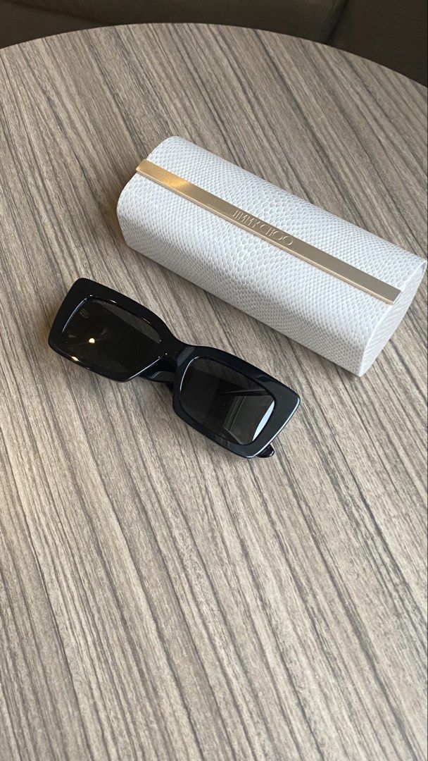 Jimmy Choo Black Rectangular Sunglasses with Case (Category: Sunglasses & Eyewear) located in Davao. Submitted by agluxefinds (Listing ID 1470379271, Image 1). Description: Authentic black acetate Jimmy Choo sunglasses with rectangular frames and dark tinted lenses. Features gold monogram hardware and side pattern. Comes with the original white textured hard case..
