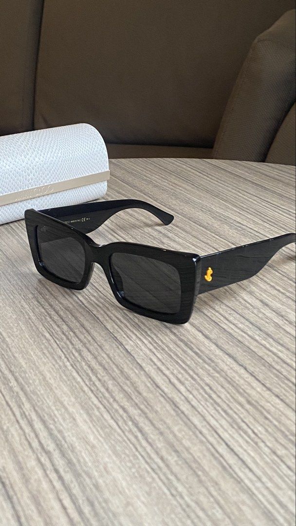 Jimmy Choo Black Rectangular Sunglasses with Case (Category: Sunglasses & Eyewear) located in Davao. Submitted by agluxefinds (Listing ID 1470379271, Image 2). Description: Authentic black acetate Jimmy Choo sunglasses with rectangular frames and dark tinted lenses. Features gold monogram hardware and side pattern. Comes with the original white textured hard case..