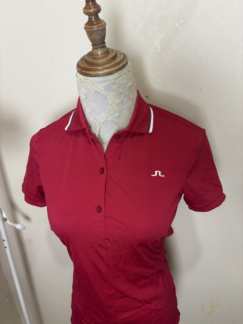 j.lindeberg Red Golf Polo Shirt (Category: Blouses) located in Ajuy. Submitted by galitsabarat (Listing ID 1470405502, Image 3). Description: EXCELLENT CONDITION DIMES 15x24.3 - Brand: J.Lindeberg - Color: Bright Red - Fit: Athletic fit fabric - Design: Short sleeves, ribbed cuffs and collar trim, front button placket - Branding: Small embroidered logo on chest, large vertical brand lettering down the back - Condition: Excellent pre-loved conditi