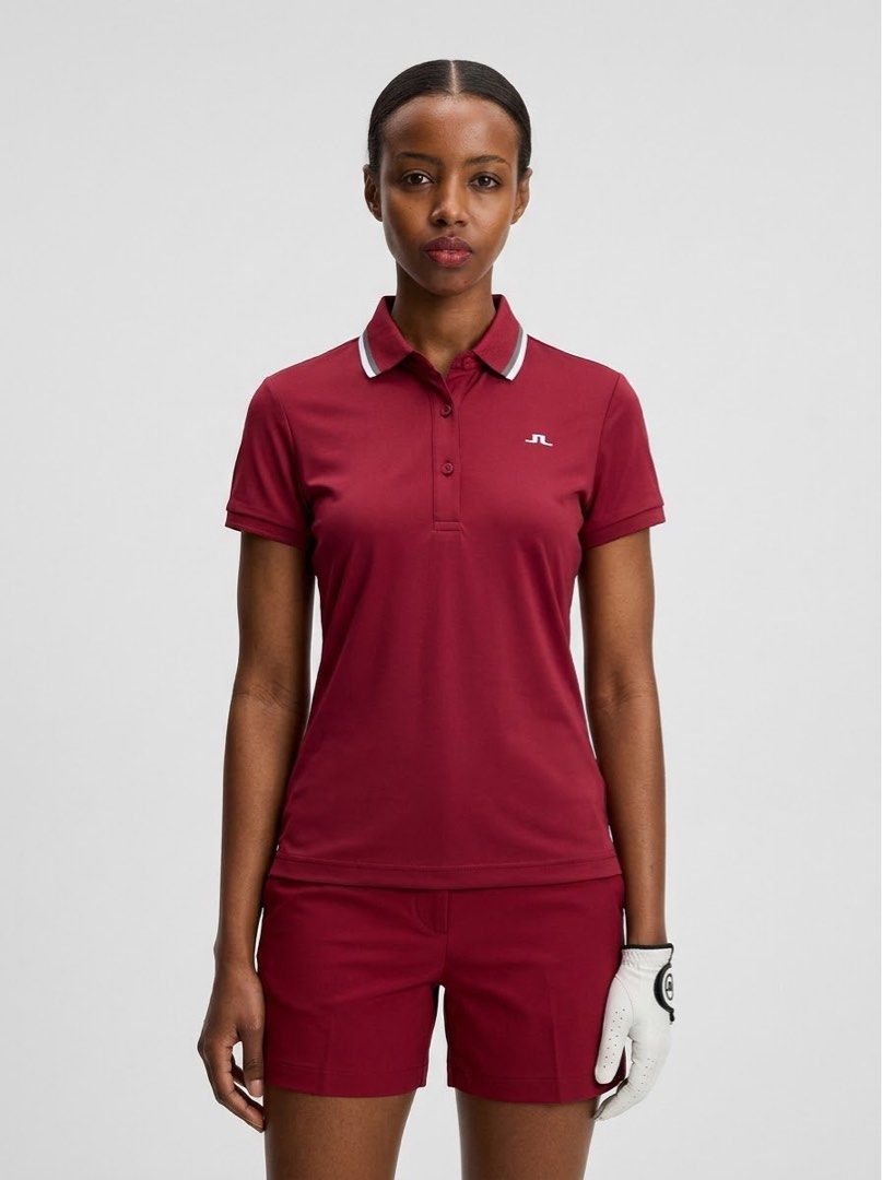 j.lindeberg Red Golf Polo Shirt (Category: Blouses) located in Ajuy. Submitted by galitsabarat (Listing ID 1470405502, Image 2). Description: EXCELLENT CONDITION DIMES 15x24.3 - Brand: J.Lindeberg - Color: Bright Red - Fit: Athletic fit fabric - Design: Short sleeves, ribbed cuffs and collar trim, front button placket - Branding: Small embroidered logo on chest, large vertical brand lettering down the back - Condition: Excellent pre-loved conditi