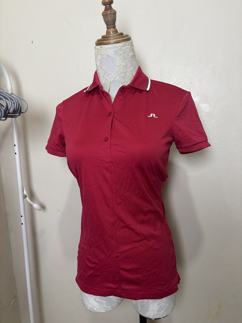 j.lindeberg Red Golf Polo Shirt (Category: Blouses) located in Ajuy. Submitted by galitsabarat (Listing ID 1470405502, Image 1). Description: EXCELLENT CONDITION DIMES 15x24.3 - Brand: J.Lindeberg - Color: Bright Red - Fit: Athletic fit fabric - Design: Short sleeves, ribbed cuffs and collar trim, front button placket - Branding: Small embroidered logo on chest, large vertical brand lettering down the back - Condition: Excellent pre-loved conditi