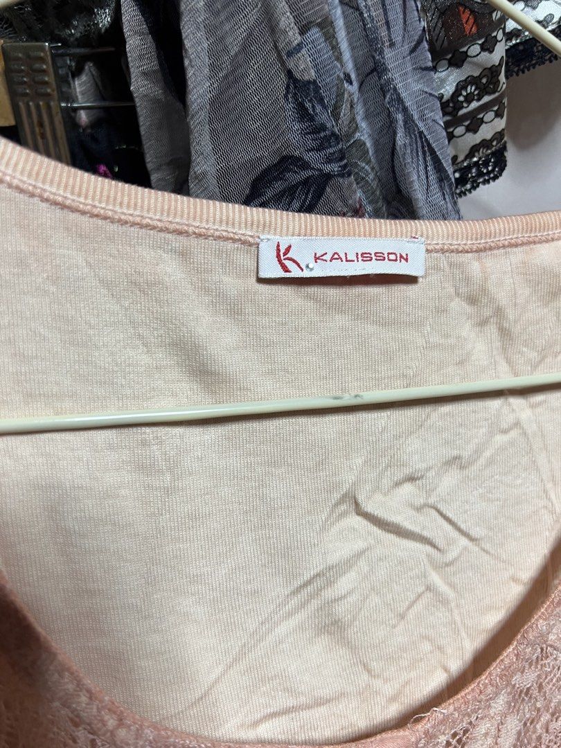 Kalisson Peach Graphic Lace Top (Category: Sleeveless) located in Manila. Submitted by threadly (Listing ID 1470399346, Image 3). Description: - Brand: Kalisson - Color: Peach with black graphic print (butterflies, clocks, and script) - Design: Scoop neckline with delicate lace details on shoulders and front button placket - Sleeves: Short sleeves - Fabric: Soft, lightweight, and comfortable - Condition: Excellent pre-loved condition - Perfect fo