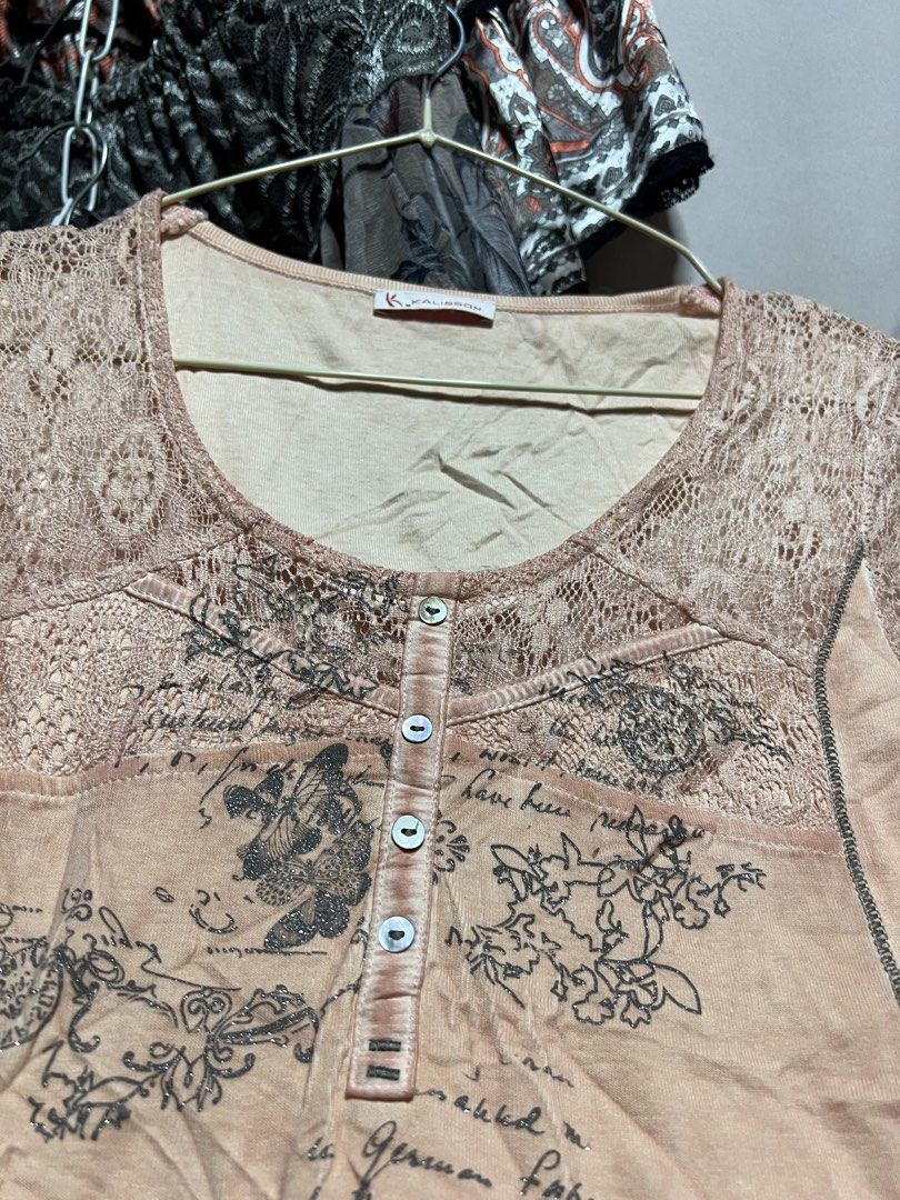 Kalisson Peach Graphic Lace Top (Category: Sleeveless) located in Manila. Submitted by threadly (Listing ID 1470399346, Image 2). Description: - Brand: Kalisson - Color: Peach with black graphic print (butterflies, clocks, and script) - Design: Scoop neckline with delicate lace details on shoulders and front button placket - Sleeves: Short sleeves - Fabric: Soft, lightweight, and comfortable - Condition: Excellent pre-loved condition - Perfect fo