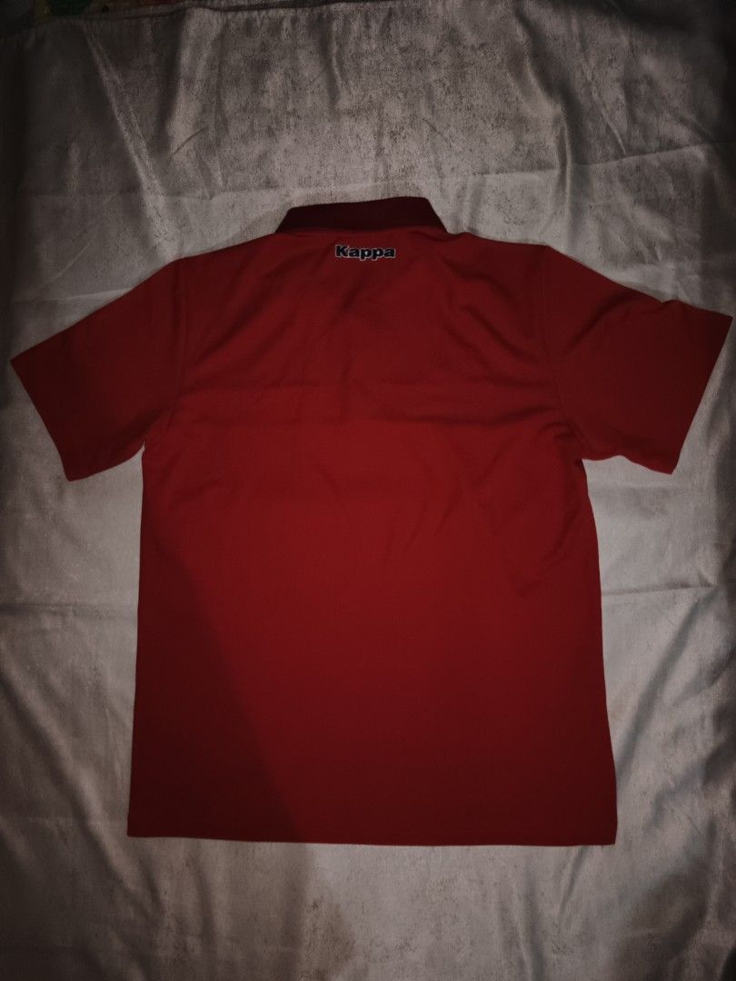 Kappa Red Polo Shirt Size L (Category: Tshirts & Polo Shirts ) located in Davao. Submitted by jjj_mncd (Listing ID 1470528835, Image 2). Description: - Brand: Kappa - Color: Red with dark blue and white chest stripe - Size: Large (Tagged) - Material: 100% Polyester (Made in Korea) - Style: Classic polo with short sleeves, collar, and button placket - Details: Features Kappa logo on the right chest and back collar - Condition: Clean, excellent ove