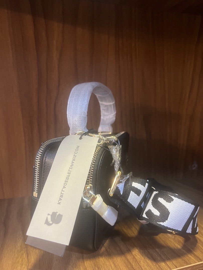 Karl Lagerfeld Paris Simone Camera Bag (Category: Cross-body Bags) located in Manila. Submitted by trustedceller (Listing ID 1470522485, Image 2). Description: Elegantly accented with gold-tone hardware and logo plaque, this crossbody by KARL LAGERFELD PARIS is crafted in leather with a double zip closure. Switch up your style and carry it by the handle or attach the webbing strap to go handsfree. Features -Small sized bag; 8”W x 5”H x 3-1/2”D (w