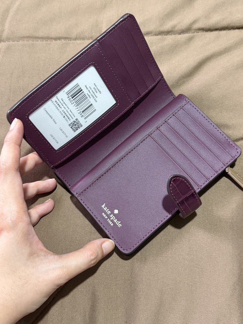 Kate Spade Medium Bifold Wallet (Category: Wallets & Card holders) located in Marikina City. Submitted by welllovedbycarina (Listing ID 1470543703, Image 3). Description: 🍇 Guaranteed original Kate Spade 🍇 Champagne gold hardwares 🍇 Croc leather pattern 🍇 Ready to ship from Marikina City 🍇 Lalamove / J&T.