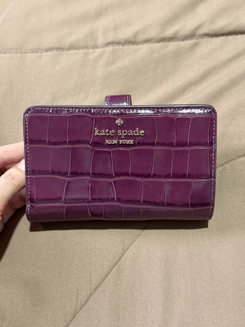 Kate Spade Medium Bifold Wallet (Category: Wallets & Card holders) located in Marikina City. Submitted by welllovedbycarina (Listing ID 1470543703, Image 2). Description: 🍇 Guaranteed original Kate Spade 🍇 Champagne gold hardwares 🍇 Croc leather pattern 🍇 Ready to ship from Marikina City 🍇 Lalamove / J&T.