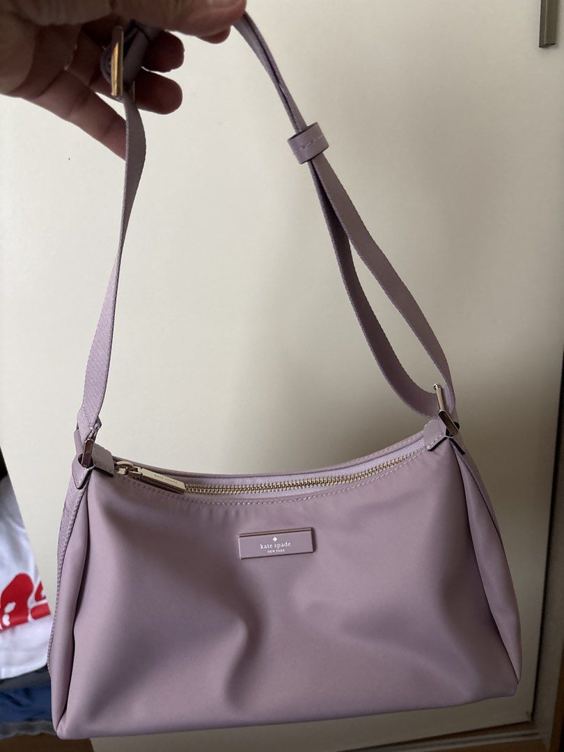 Kate Spade New York Shoulder Bag (Category: Shoulder Bags) located in Bulacan. Submitted by emgjoanag44033 (Listing ID 1470391999, Image 2). Description: - Brand: Kate Spade New York - Color: Dusty Lavender - Material: Smooth nylon with gold-tone hardware - Closure: Top zipper - Features: Metal logo plaque, adjustable strap with buckle details - Condition: Excellent / Pre-loved (ready for daily use) - Style: Lightweight, simple, and versatile dai