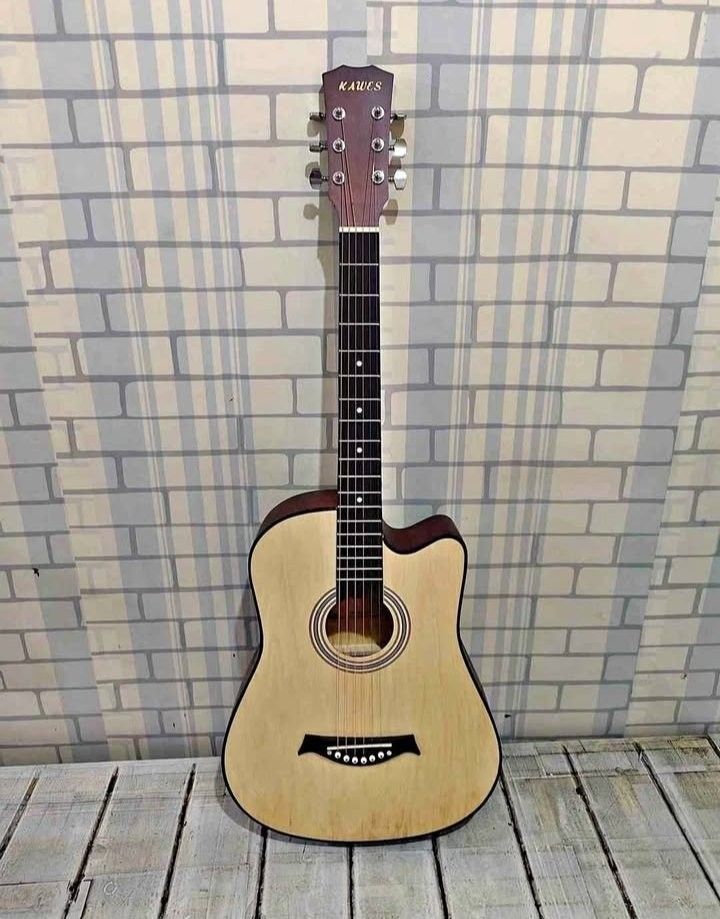 Kawes acoustic guitar (Category: Musical Instruments) located in Manila. Submitted by jmmmmch00 (Listing ID 1470477482, Image 1). Description: - Brand: KAWES Acoustic Guitar - Body Style: Cutaway for easy upper fret access - Finish: Natural light wood top with contrasting dark sides and back - Hardware: Chrome tuning pegs and patterned soundhole rosette - Setup: Standard 6-string with black bridge and dot-marker fretboard - Condition: Solid build