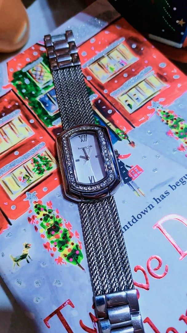 Kenneth Cole New York Crystal Rectangle Wristwatch Silver Mesh Strap (Category: Women's Watches) located in Baliuag. Submitted by marieannfernando23 (Listing ID 1470368402, Image 2). Description: - Brand: Kenneth Cole - Style: Silver-tone rectangular face watch with minimalist dial - Accents: Sparkling crystals on the bezel, Roman numerals at 12 and 6 o'clock - Strap: Unique woven mesh metal bracelet - Movement: Reliable quartz movement - Versati