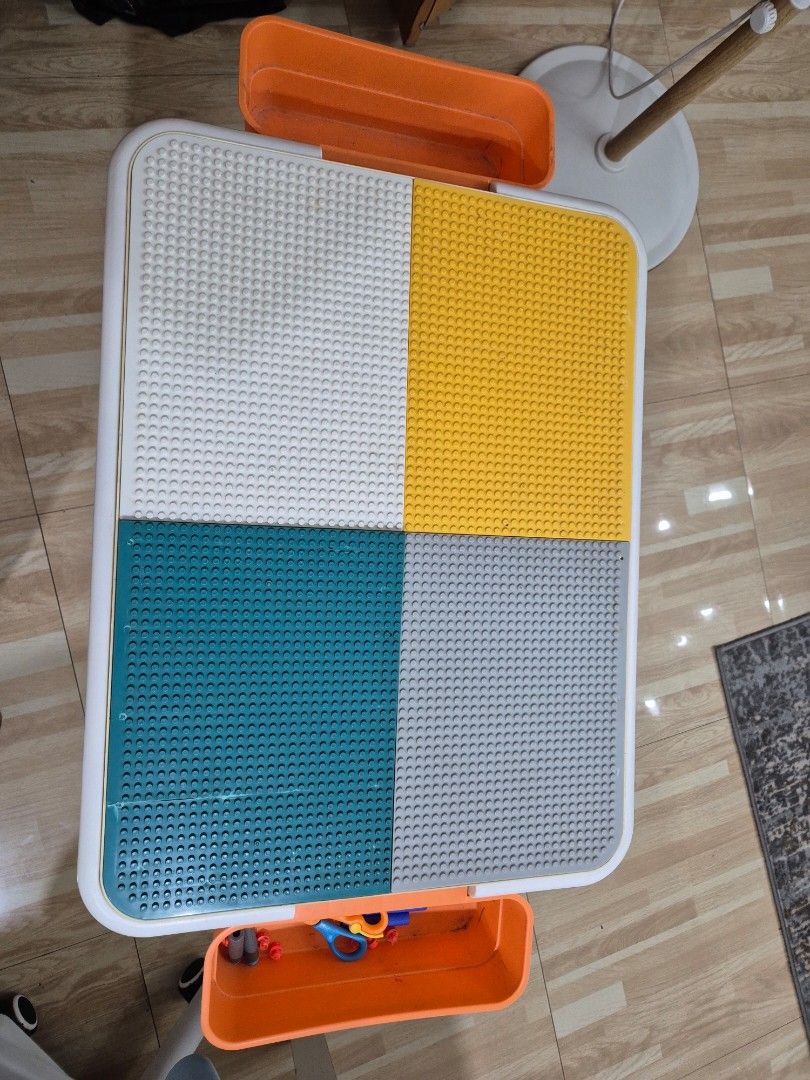 Kids multi-functional activity play table with Lego building board (Category: Kids Tables & Chairs) located in Manila. Submitted by bajoyskie (Listing ID 1470441488, Image 2). Description: - Convertible top: flips between a Lego building block board and a smooth surface - Spacious built-in storage compartment underneath for toys and blocks - Comes with two convenient hanging side trays - Stylish teal legs with a clean white frame - Condition: Sho