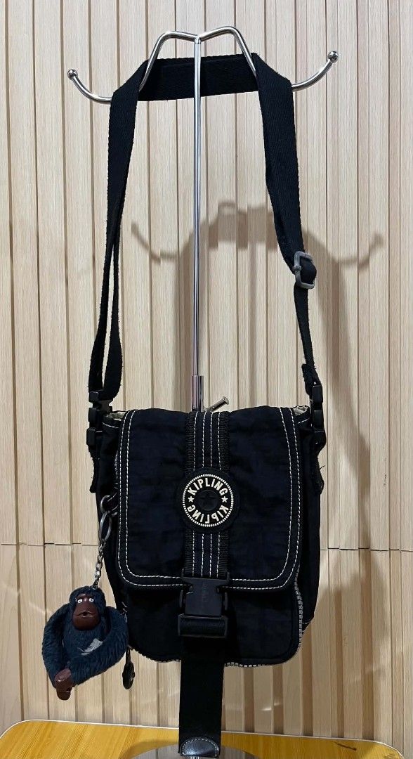 Kipling Black Crossbody Bag with Monkey Keychain (Category: Cross-body Bags) located in Daraga. Submitted by thethriftcity2024 (Listing ID 1470557339, Image 1). Description: - 100% Authentic Kipling crossbody bag in classic black crinkled nylon - Features iconic round logo patch, quick-release buckle, and contrasting white stitching - Includes the signature fuzzy monkey keychain - Adjustable thick shoulder strap for comfortable wear - Multiple in