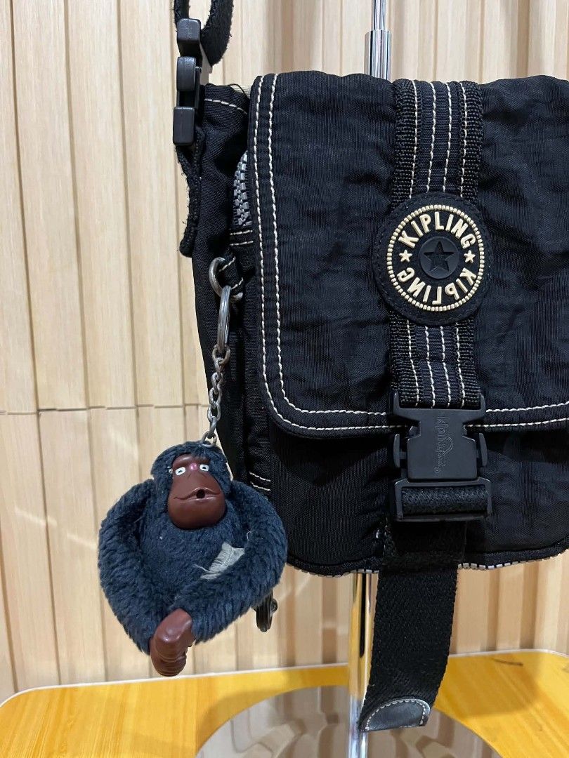 Kipling Black Crossbody Bag with Monkey Keychain (Category: Cross-body Bags) located in Daraga. Submitted by thethriftcity2024 (Listing ID 1470557339, Image 2). Description: - 100% Authentic Kipling crossbody bag in classic black crinkled nylon - Features iconic round logo patch, quick-release buckle, and contrasting white stitching - Includes the signature fuzzy monkey keychain - Adjustable thick shoulder strap for comfortable wear - Multiple in
