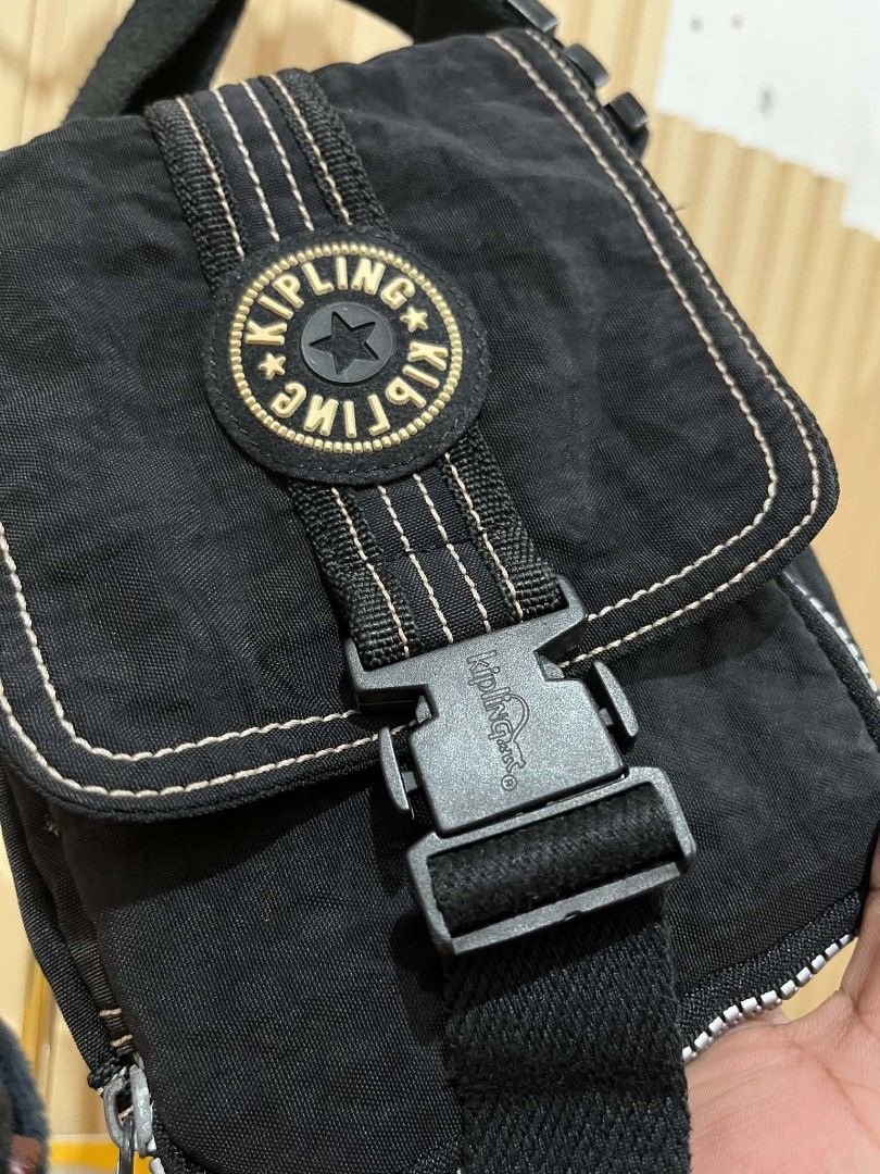 Kipling Black Crossbody Bag with Monkey Keychain (Category: Cross-body Bags) located in Daraga. Submitted by thethriftcity2024 (Listing ID 1470557339, Image 3). Description: - 100% Authentic Kipling crossbody bag in classic black crinkled nylon - Features iconic round logo patch, quick-release buckle, and contrasting white stitching - Includes the signature fuzzy monkey keychain - Adjustable thick shoulder strap for comfortable wear - Multiple in