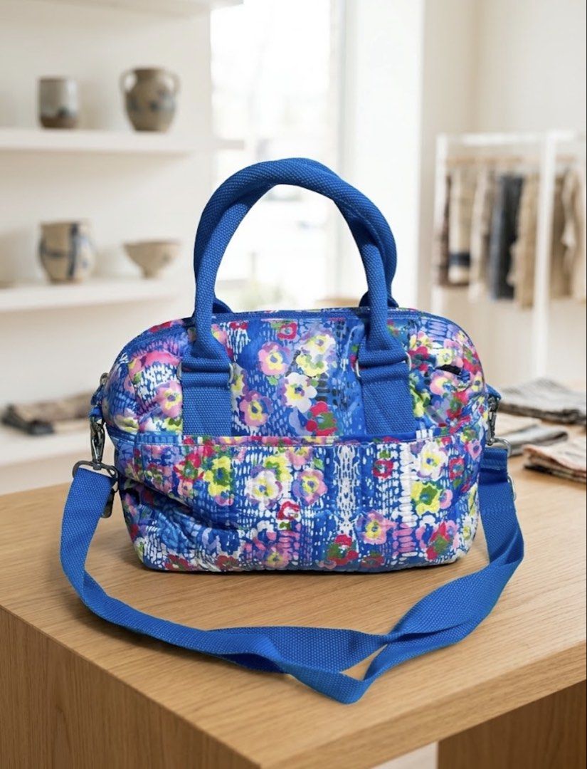 Kipling Blue Floral Handbag with Shoulder Strap (Category: Shoulder Bags) located in Manila. Submitted by goldenphoenix_ac6904 (Listing ID 1470480813, Image 2). Description: - Brand: Kipling - Design: Blue floral pattern with silver-tone hardware and iconic round logo badge - Carry Options: Dual top handles + adjustable, detachable shoulder strap - Pockets: Front exterior pocket, plus interior zip and slip pockets - Extras: Fun black and white ch