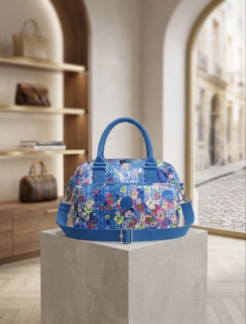 Kipling Blue Floral Handbag with Shoulder Strap (Category: Shoulder Bags) located in Manila. Submitted by goldenphoenix_ac6904 (Listing ID 1470480813, Image 1). Description: - Brand: Kipling - Design: Blue floral pattern with silver-tone hardware and iconic round logo badge - Carry Options: Dual top handles + adjustable, detachable shoulder strap - Pockets: Front exterior pocket, plus interior zip and slip pockets - Extras: Fun black and white ch
