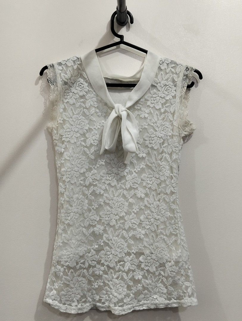 Laced sleeves top (Category: Sleeveless) located in Manila. Submitted by nanalovedthrifts (Listing ID 1470361410, Image 1). Description: White lace sleeves top with attached ribbon tie ✨ Message if interested/for inquiries ✨XS-SMALL.
