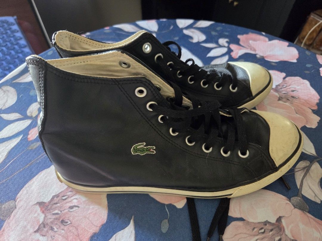 Lacoste Black High-Top Leather Sneakers (Category: Sneakers) located in Pasig City. Submitted by tatashki (Listing ID 1470390142, Image 1). Description: - Brand: Lacoste - Style: Black leather high-top sneakers - Details: White rubber toe caps and midsoles, black laces, embroidered side crocodile logo, and LACOSTE heel branding - Condition: Pre-owned with scuffing/discoloration on the toe caps and minor glue separation along the side sole (please