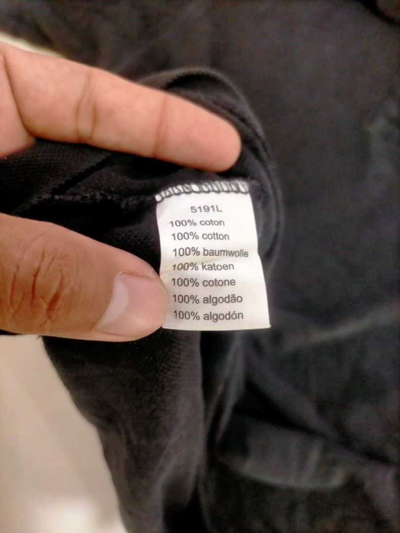 Lacoste Black Polo Shirt Size 6 (Category: Tshirts & Polo Shirts ) located in Manila. Submitted by zenphoenix_b0c89e (Listing ID 1470443482, Image 3). Description: - Brand: Lacoste - Color: Black - Size: 6 (Standard fit) - Material: 100% Cotton (Style: 5191L, Made in Peru) - Design: Short sleeves, button placket - Branding: Iconic green embroidered crocodile logo on the chest - Condition: Breathable and comfortable fabric.