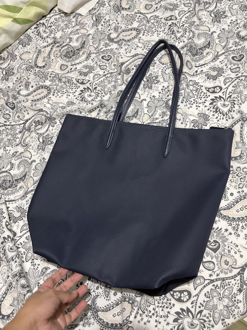 Lacoste L.12.12 Concept Vertical Zip Tote Bag (Category: Tote Bags) located in Mapandan. Submitted by thrifty.nifty.tara (Listing ID 1470454507, Image 3). Description: Used once Authentic Purchased in Amazon US (Lacoste store) Penombre blue One interior zip net pocket with hook Lacoste branded zipper slider Embroidered Tone-on-Tone Crocodile branding Outside: Pvc (100%).
