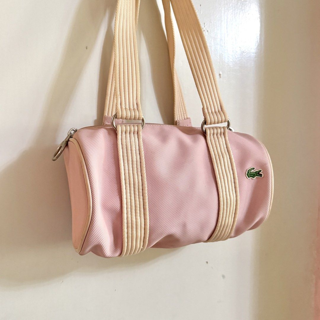Lacoste Mini Barrel Bag (Category: Luxury Bags & Wallets) located in Cavite. Submitted by vintage.bratz (Listing ID 1470394169, Image 2). Description: • Pink • Well taken care of (lady owned) • No rubs on canvas • Needs a little cleaning.