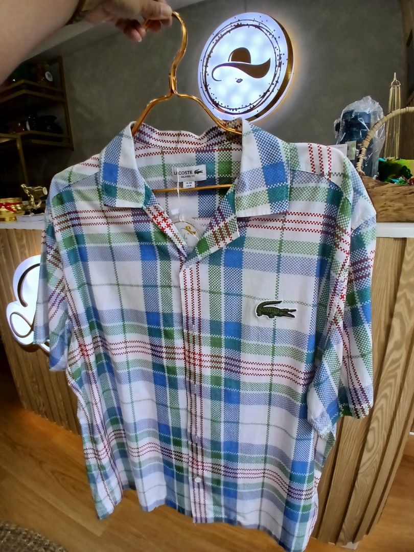 Lacoste Plaid Button-Up Long Sleeve Shirt (Category: Coats, Jackets and Outerwear) located in Manila. Submitted by charlene_selda29 (Listing ID 1470385374, Image 1). Description: - Brand: Lacoste - Style: Long sleeve button-up shirt in a multi-color plaid pattern (white, blue, green, red) - Details: Classic collar, front button closure, and chest pocket - Logos: Signature embroidered crocodile on the chest and a statement neon yellow printed croc