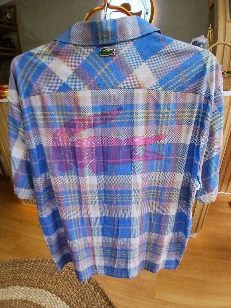 Lacoste Plaid Button-Up Shirt Blue White (Category: Tshirts & Polo Shirts ) located in Manila. Submitted by charlene_selda29 (Listing ID 1470385458, Image 2). Description: - Brand: Lacoste - Design: Blue, white, and purple plaid pattern - Fit: Relaxed fit, lightweight fabric with long sleeves - Details: Button-down front, classic collar - Branding: Small embroidered green crocodile logo on the left chest - Condition: Excellent pre-loved condition