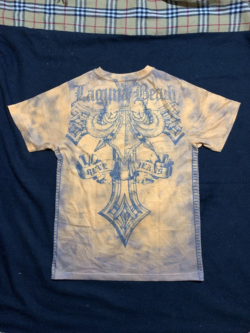 Laguna Beach Jean Co. Graphic Tee Size M (Category: Tshirts & Polo Shirts ) located in Cagayan de Oro. Submitted by chabermz (Listing ID 1470532475, Image 2). Description: - Brand: Laguna Beach Jean Co. - Design: Yellow and grey tie-dye with ornate cross crest print on front and back - Size: Medium (M) - Material: 65% Polyester, 35% Rayon - Origin: Made in Korea - Style: Vintage streetwear, short sleeves, crew neck - Condition: Excellent pre-love