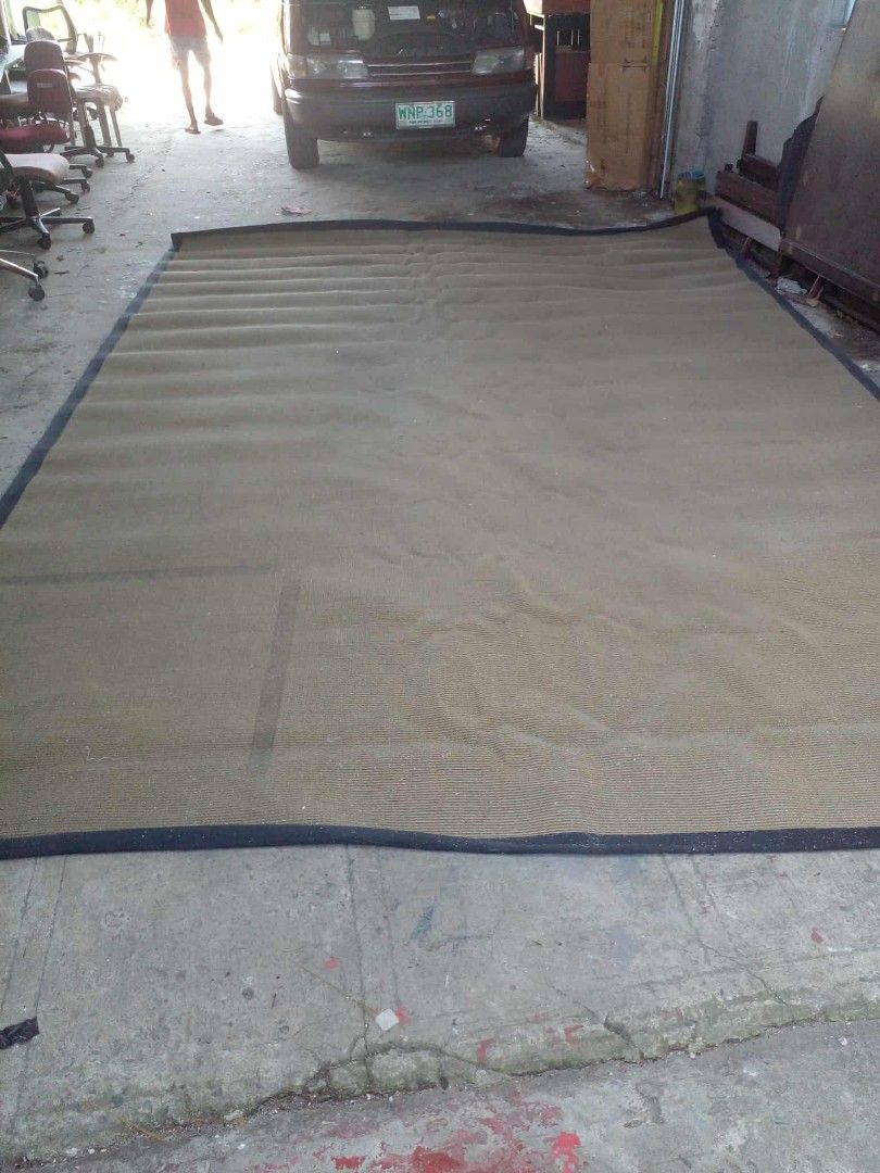 Large brown woven area rug with dark border (Category: Carpets, Mats & Flooring) located in Manila. Submitted by wisegem-231b (Listing ID 1470398936, Image 2). Description: - Type: Large floor carpet - Material: Brown woven material with dark blue border trim - Shape: Rectangular - Size: Spacious, covers a big floor area - Style: Neutral earthy tone suitable for living rooms, bedrooms, or office spaces.